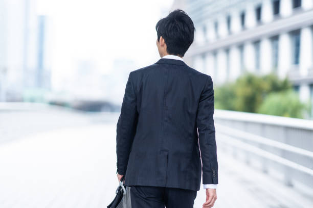 A man in a suit walking in the business district