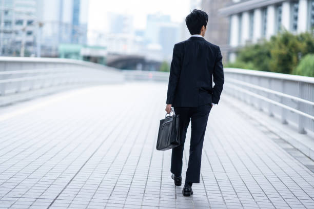 istock A man in a suit walking in the business district 1449221410