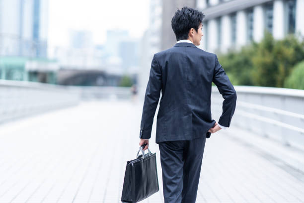 istock A man in a suit walking in the business district 1449221429