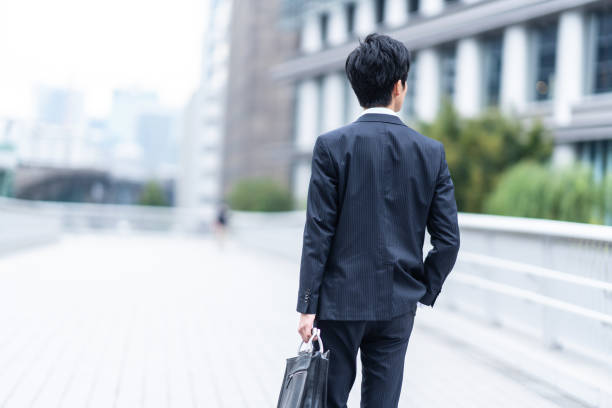 istock A man in a suit walking in the business district 1449221461