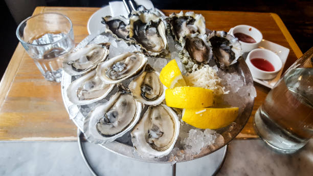 istock opened oysters and lemons on the plate on the table 1449225808