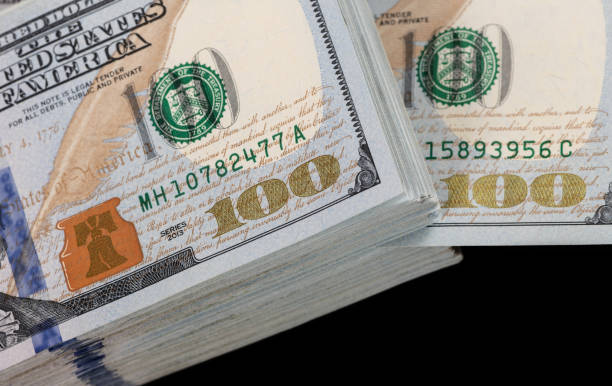 istock A stack of 100 american dollars banknotes on a black background 1449232163