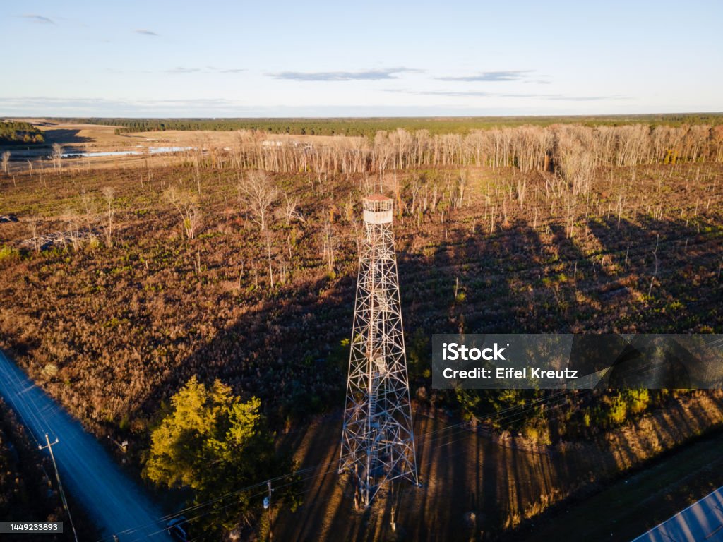 Aerial View of Fire Tower in Rural Farmland Drone view of historic Tuscarora Fire Tower in rural eastern North Carolina near New Bern. Aerial View Stock Photo