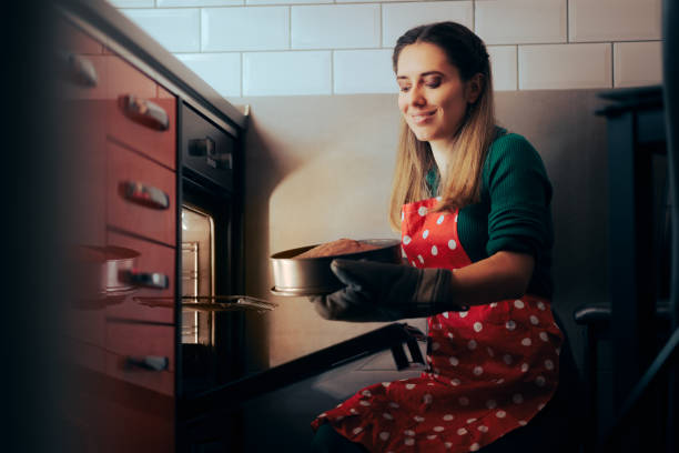istock Happy Woman Baking a Homemade Cake Successfully 1449239302