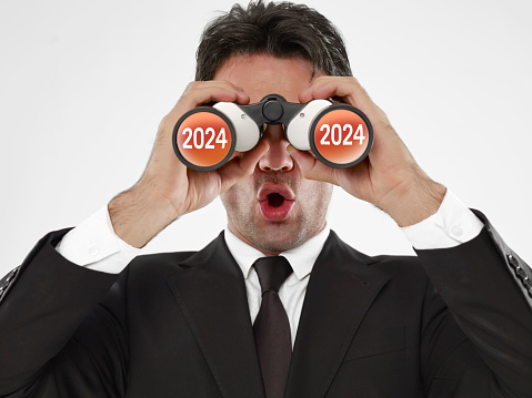 businessman looking at year 2023 with binoculars