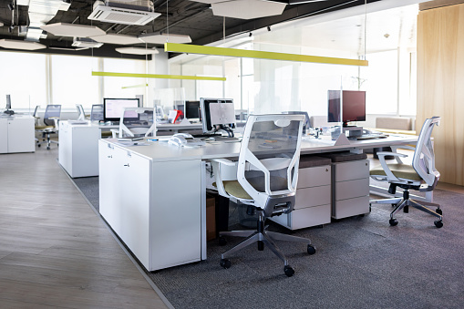 Modern office space with several cubicles and no people -