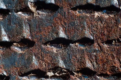Rusty teeth of a file on wood close-up, macro photography