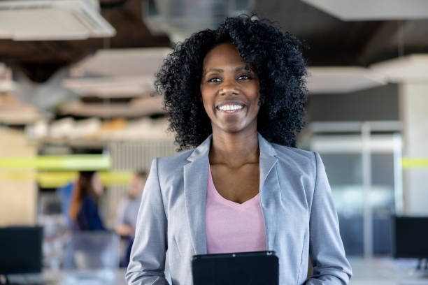istock Happy business woman working at the office and using a tablet computer 1449248250