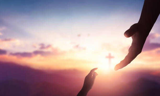 Religion and salvation concept:God reaching out to help people on cross background stock photo