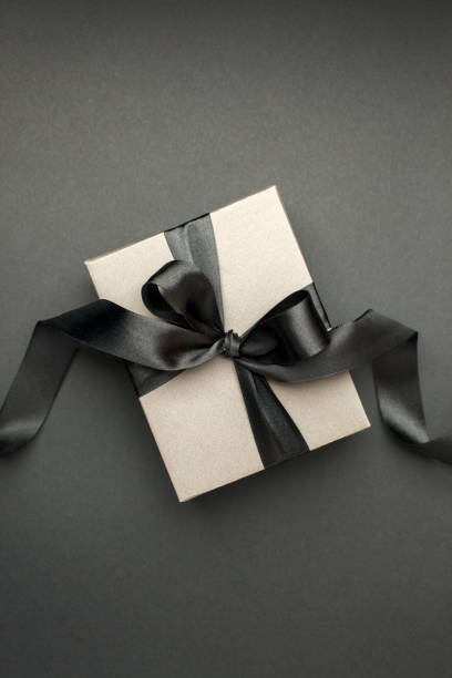 istock Craft gift box on a dark background, decorated with a textured bow, creating a romantic luxury atmosphere. For birthday, anniversary presents, gift post cards, banner, flyer, invitation, voucher 1449251146