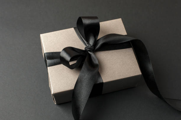 istock Craft gift box on a dark background, decorated with a textured bow, creating a romantic luxury atmosphere. For birthday, anniversary presents, gift post cards, banner, flyer, invitation, voucher 1449251152