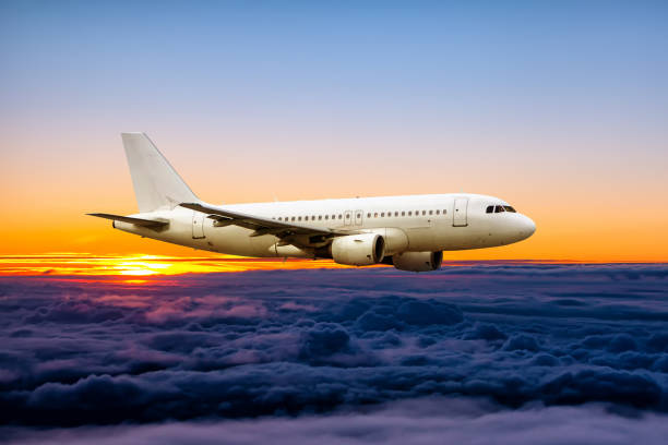istock White passenger airplane fly in the sunrise sky 1449254600