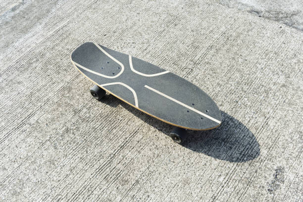 istock surfskate or skateboard top veiw on concrete road with shadow 1449255648