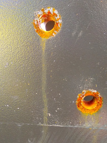 Rust screw hole on metal picture