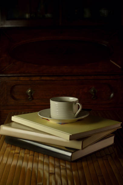 Still life with ripe persimmons, old books, cups and plants