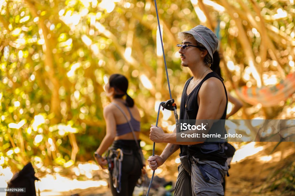 The Belayer role in rock climbing The rock climbing team does a good job of Belayer on the ground Achievement Stock Photo