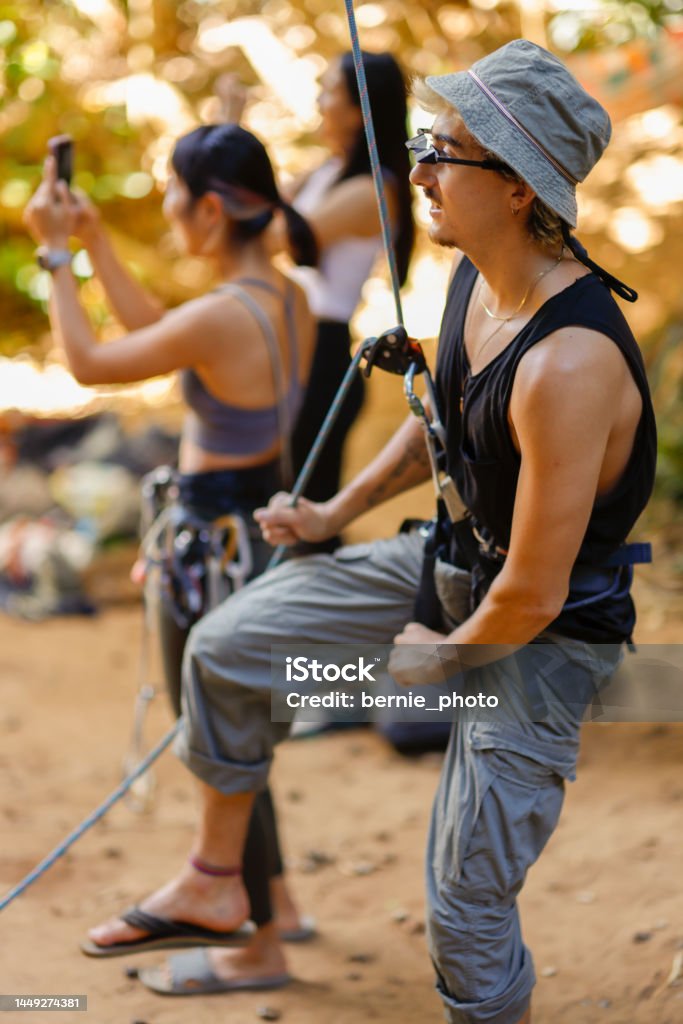 The Belayer role in rock climbing The rock climbing team does a good job of Belayer on the ground Achievement Stock Photo