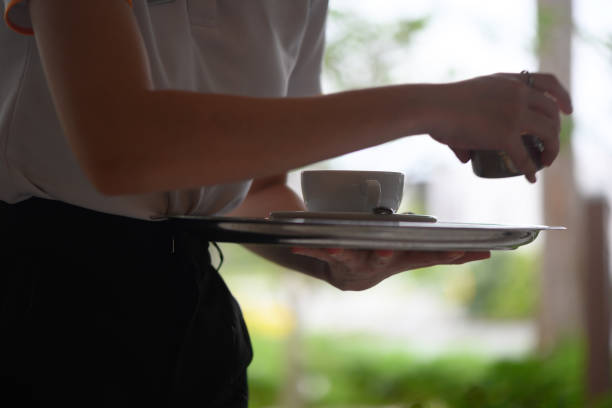 istock Waitress carrying a serving tray with a cup of coffee 1449278912