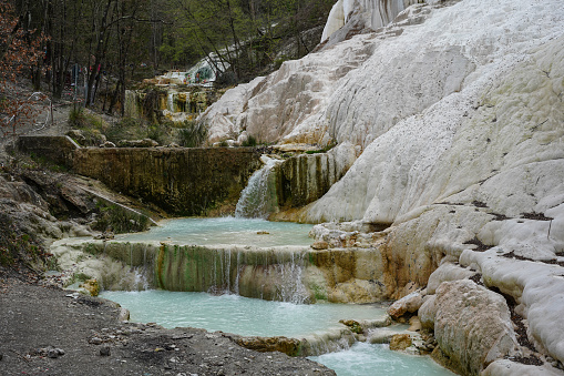 Hot springs at Bagni San Filippo, Italy, with calcium carbonate deposits surrounding the thermal water