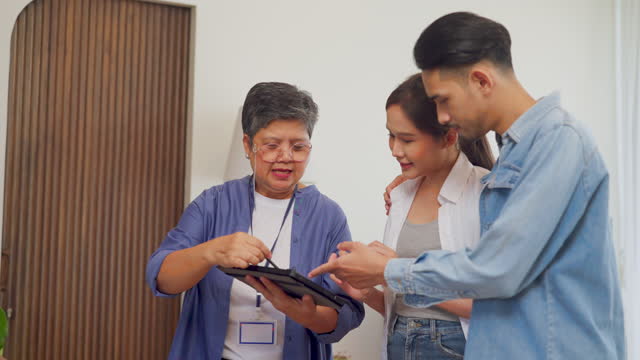 Stay focused on the business aspect.Crop shot of young happy family purchasing new house from Real Estate Agent indoors. Housing and real estate business concept.