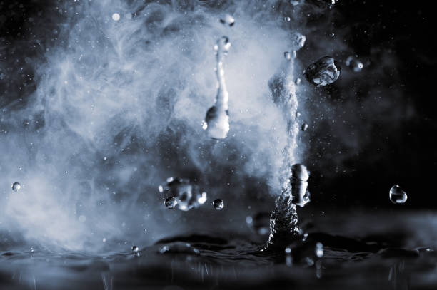 istock Boiling water splash with steam on black background closeup 1449282543
