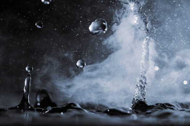 istock Boiling water splash with steam on black background closeup 1449282577
