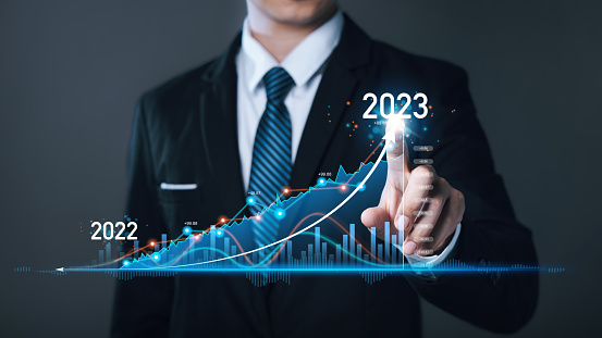 Businessman draws arrow graph corporate for planning businesses finance and investment challenges, and business strategy. Goals and Visions to success for corporate future in 2023