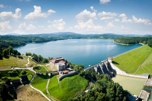 A water dam with a power plant and ruins of medieval castle on Lake Dobczyce in Malopolska province, Poland
