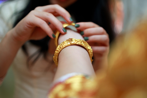 Tradition in Chinese wedding where bride will be gifted with all kinds of gold jewellery by family during tea ceremony