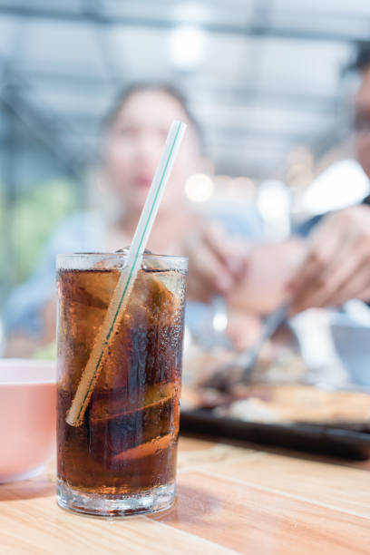 Soft drink in glasses with ice on the table with woman blur background at Thai local restaurants