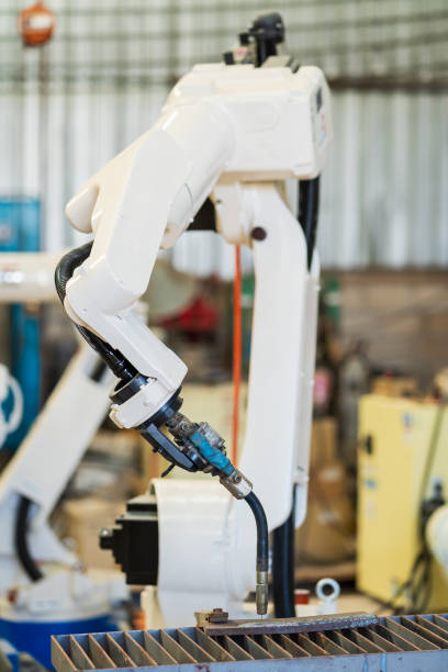 istock Robotic arm ready for work at production line in smart factory industrial. Automatic robot arm system welding machine in the industry factory. Industrial robot manufacturing technology 1449285662