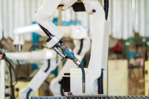 istock Robotic arm ready for work at production line in smart factory industrial. Automatic robot arm system welding machine in the industry factory. Industrial robot manufacturing technology 1449285675