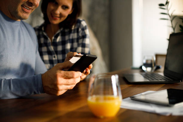 istock Lovely couple using laptop for online shopping. 1449288022
