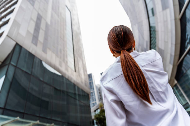 istock Businesswoman walking outside office building 1449291981