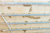 View on unfinished gypsum ceiling with aluminum profiles, frame for plasterboard