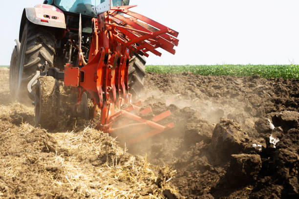 Tractor plowing stock photo