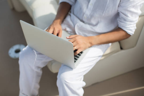 Businessman working with computer on a boat, nice outdoor office