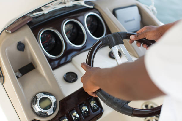 istock Yacht's captain holds the wheel with his hands 1449294536