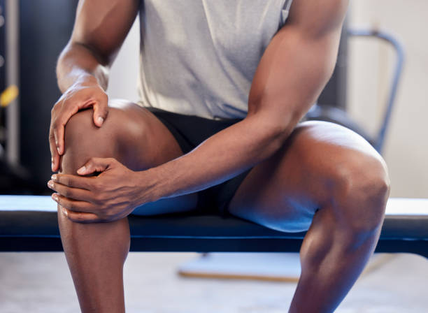 Knee pain, fitness and sports black man injury at gym after workout exercise. Closeup male athlete orthopedic problem, fibromyalgia emergency and medical arthritis during leg training at health club Knee pain, fitness and sports black man injury at gym after workout exercise. Closeup male athlete orthopedic problem, fibromyalgia emergency and medical arthritis during leg training at health club limb body part stock pictures, royalty-free photos & images