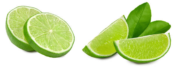 istock cut of green lime with leaves isolated on white background. clipping path 1449296539