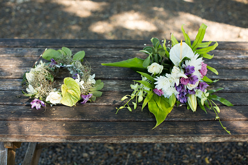 wedding bouquet and wreath on a wooden table
