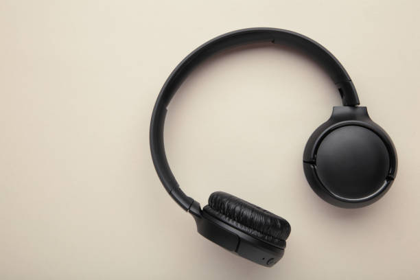 istock Black, modern wireless headphones on a grey background. 1449298425