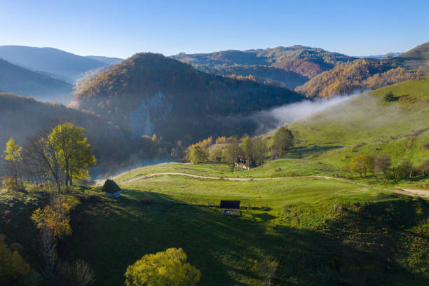 mountain countryside homestead in the autumn. wooden barns, aerial drone view - transylvania imagens e fotografias de stock