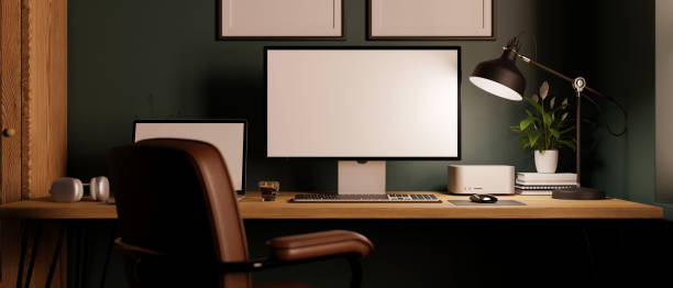 istock Modern stylish workstation with computer and decor on wood table against the dark green wall 1449305136