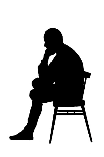 silhouette of a middle aged man sitting  on white
