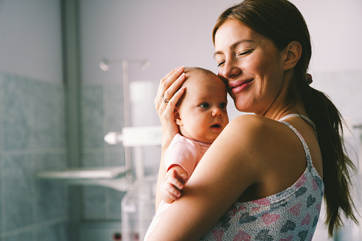 Portrait of a beautiful mother with her newborn baby