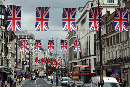 London, UK - June 24, 2022: A display of Union Jack flags above the traffic along The Strand in central London, UK.