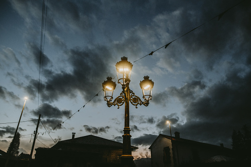 Illuminated street lamp at dusk