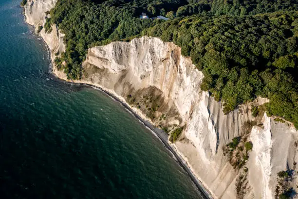 Drone’s eye view of the spectacular chalk cliffs at Moens Klint on the island of Møn in Denmark. Photographed in the early autumn, colour, horizontal format with some copy space.