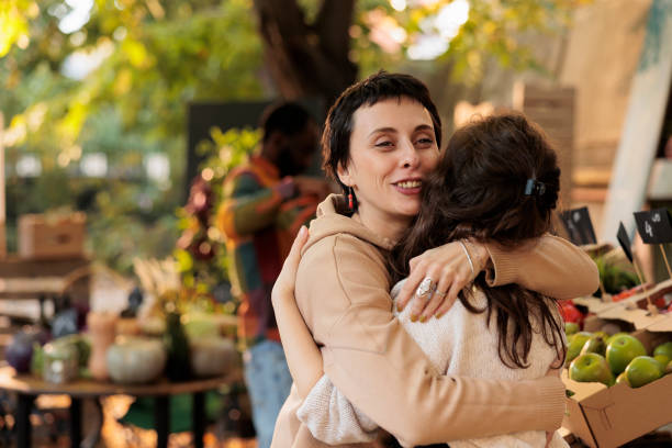 istock Friendly farm stand seller hugging happy loyal client 1449311023